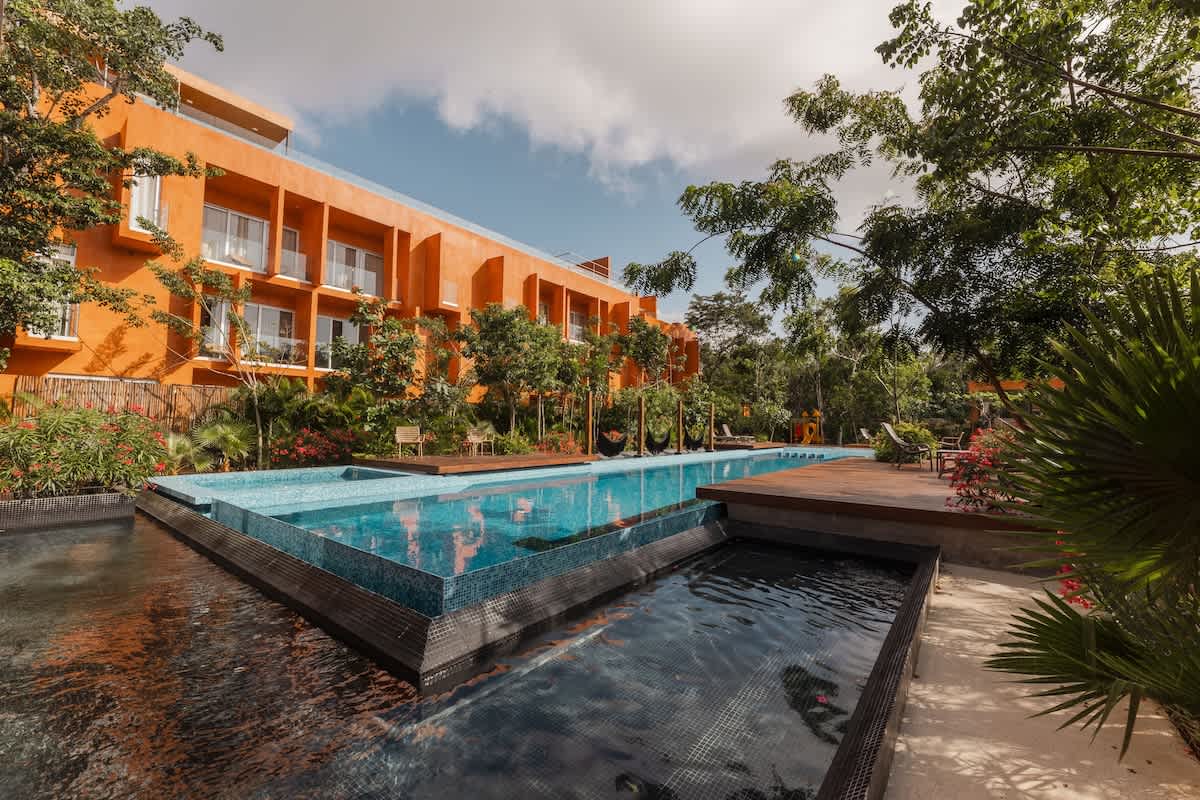 Shared Semi-Olympic Pool: Enjoy a beautiful semi-Olympic pool surrounded by lush tropical gardens.