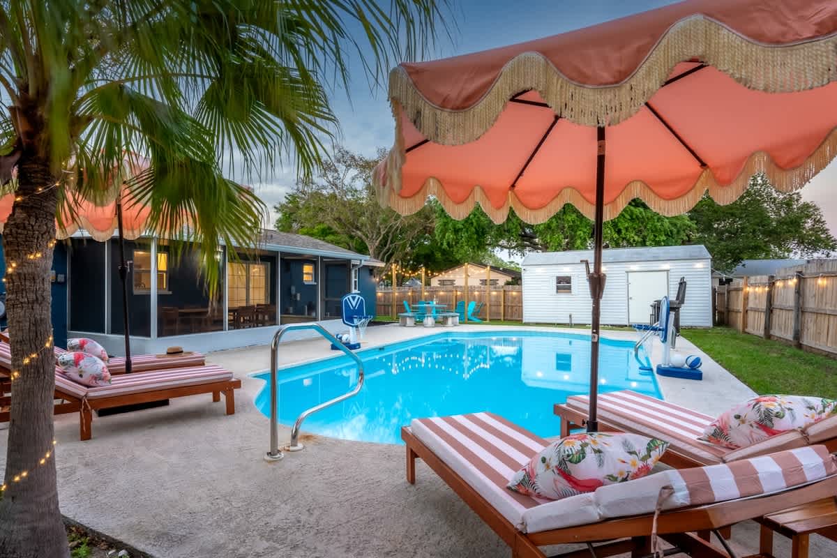 Outdoor Oasis: Dive into relaxation by the shimmering pool, surrounded by tropical charm!