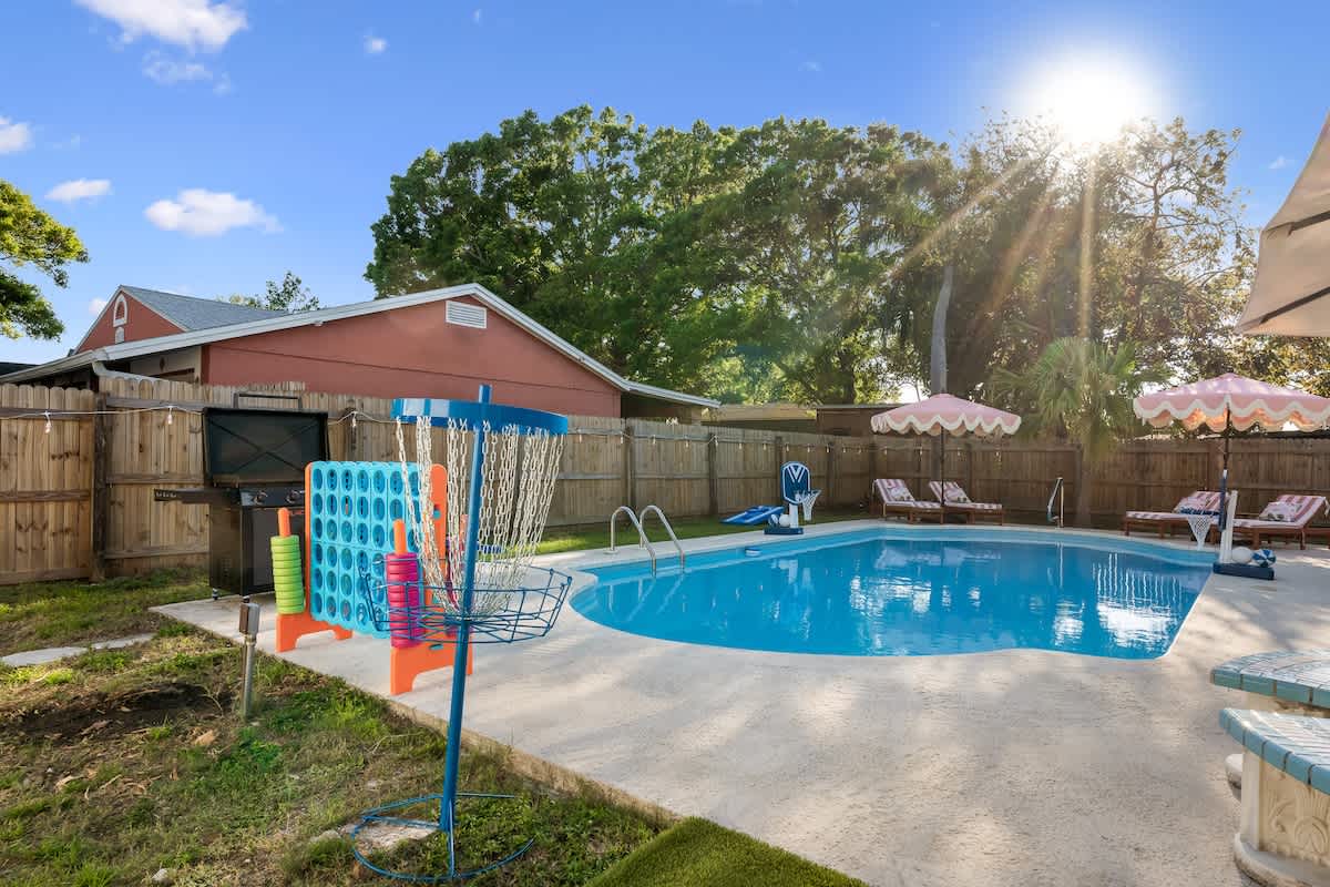 Backyard Oasis: Dive into fun with a sparkling pool, colorful games, and sunny lounging spots!