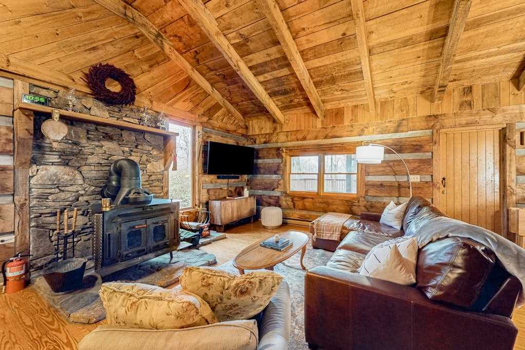 Secluded dog-friendly cabin with firepit, large deck, forest views, & wood stove