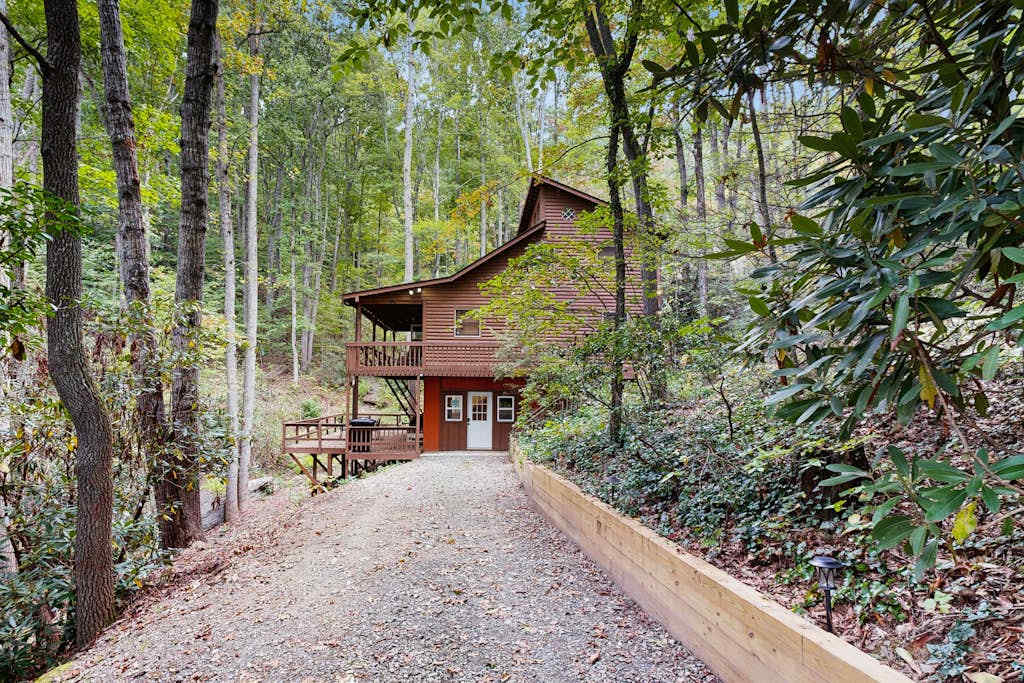 Mountain home nestled in the forest with a stream, deck, firepit, & game room