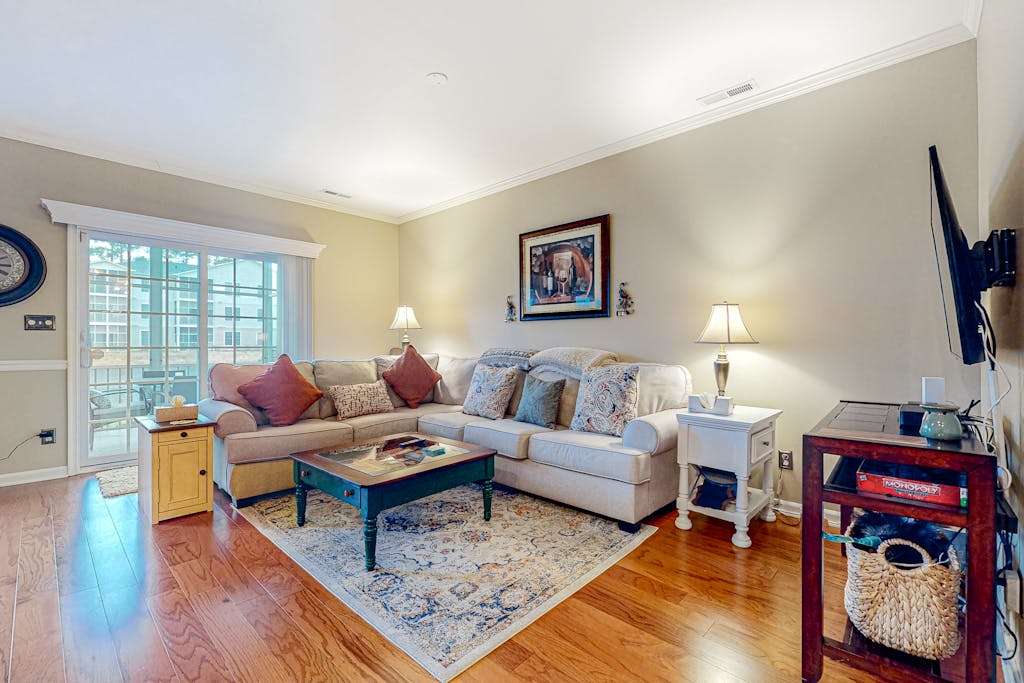 The Tides townhome with pond front balcony screened patio & pool