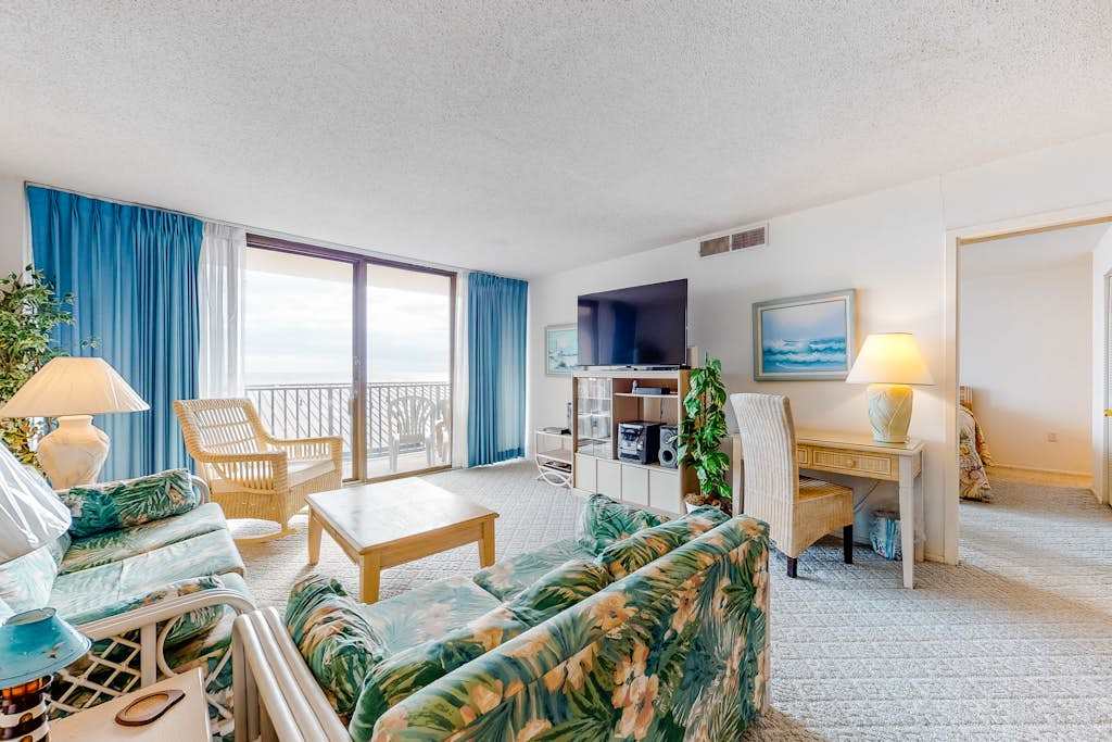 Sea Colony 4th floor condo with shared pool basketball court with a partial ocean view & two assigned parking spaces