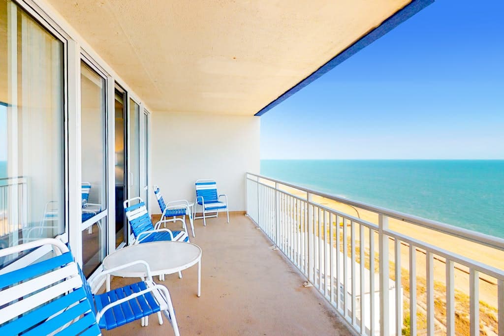 Recently updated beachfront condo with balcony, AC, pools, sauna, & game room