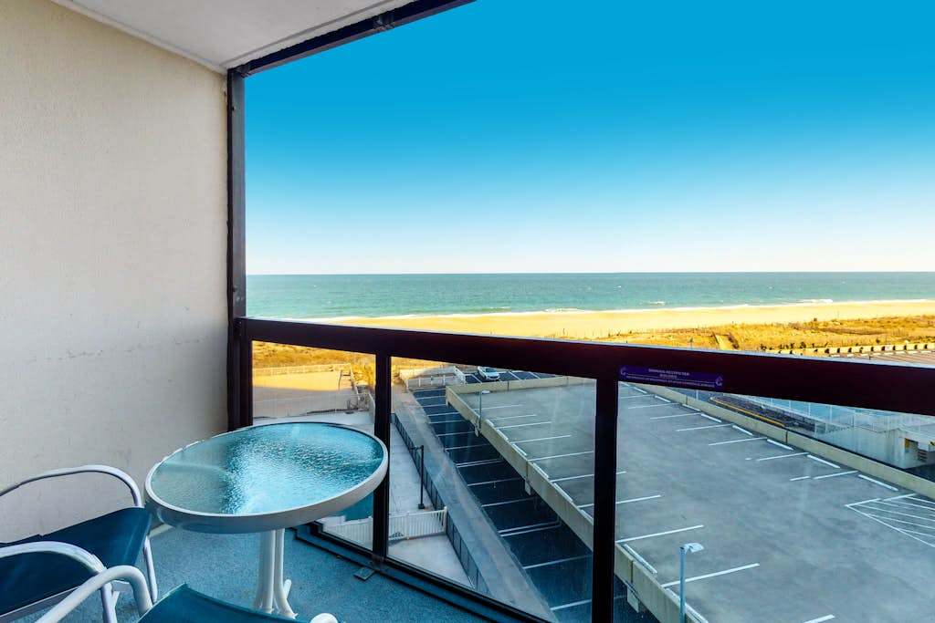 Modern beach retreat with balcony views, pools, gym & tennis