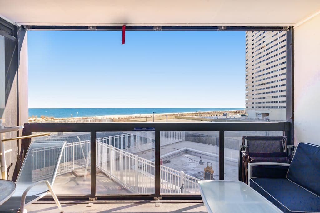 Convenient & affordable condo with angled ocean views, pools & gym