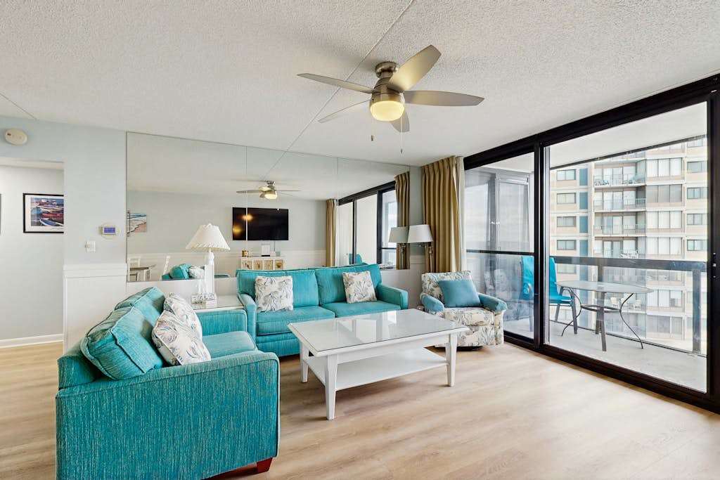Stunning beachfront condo with balcony, tennis & beach views, pools, gym, & AC