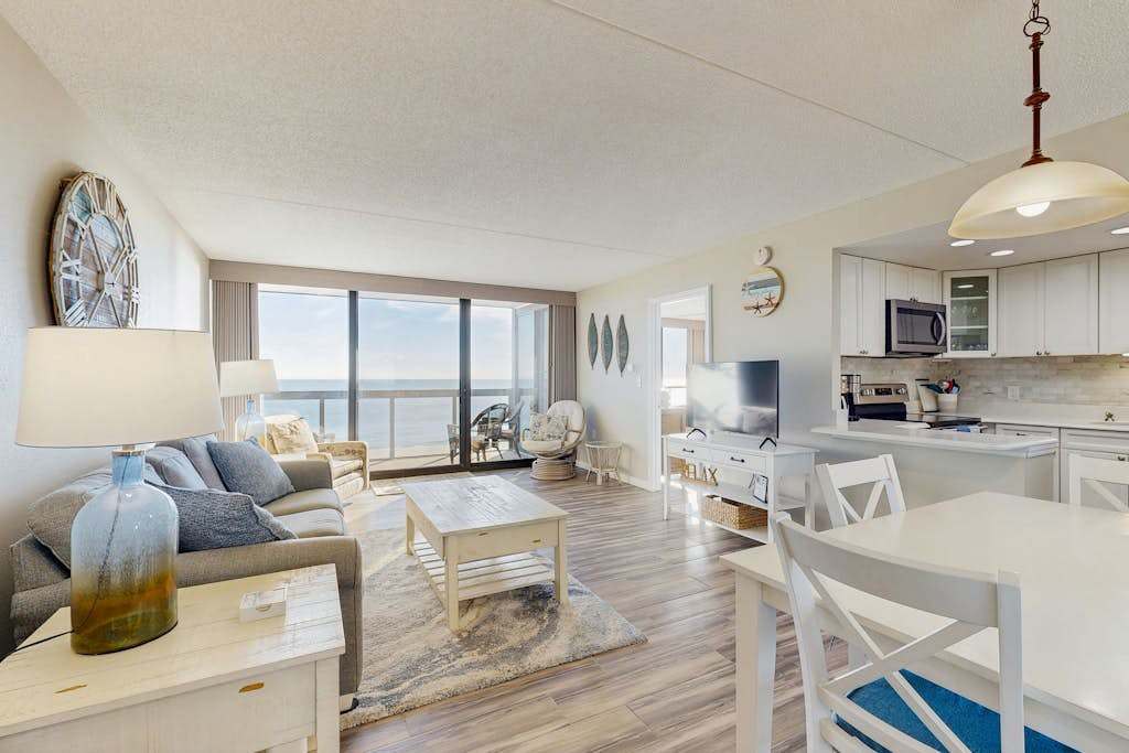 Convenient beachfront condo with balcony, pools, tennis, gym & central AC