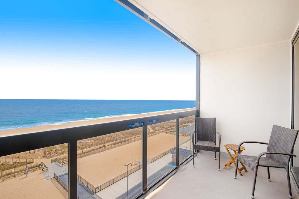 Wonderful beachfront condo with scenic balcony, AC, washer & dryer, pools, gym, & tennis