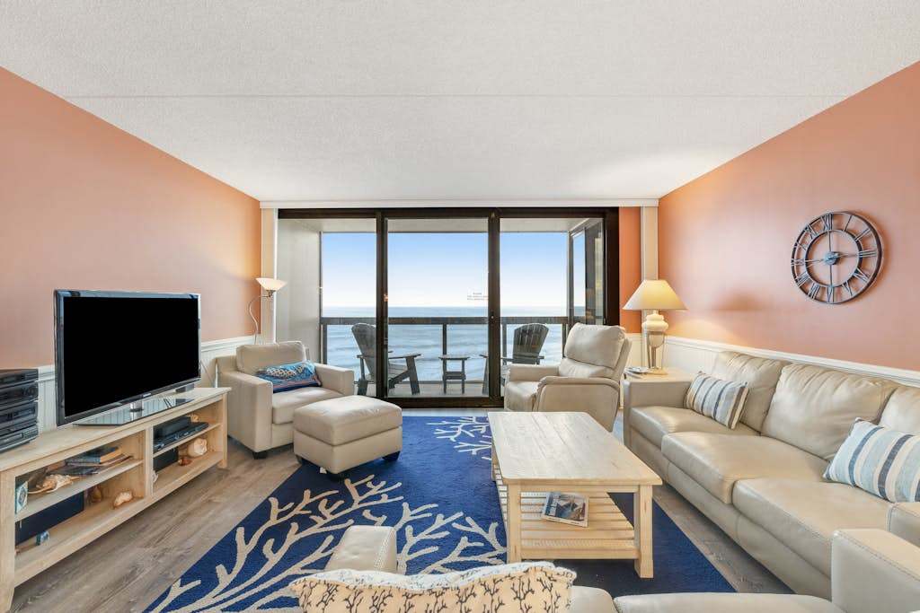 Coastal-themed beachfront condo with angled ocean views & pools