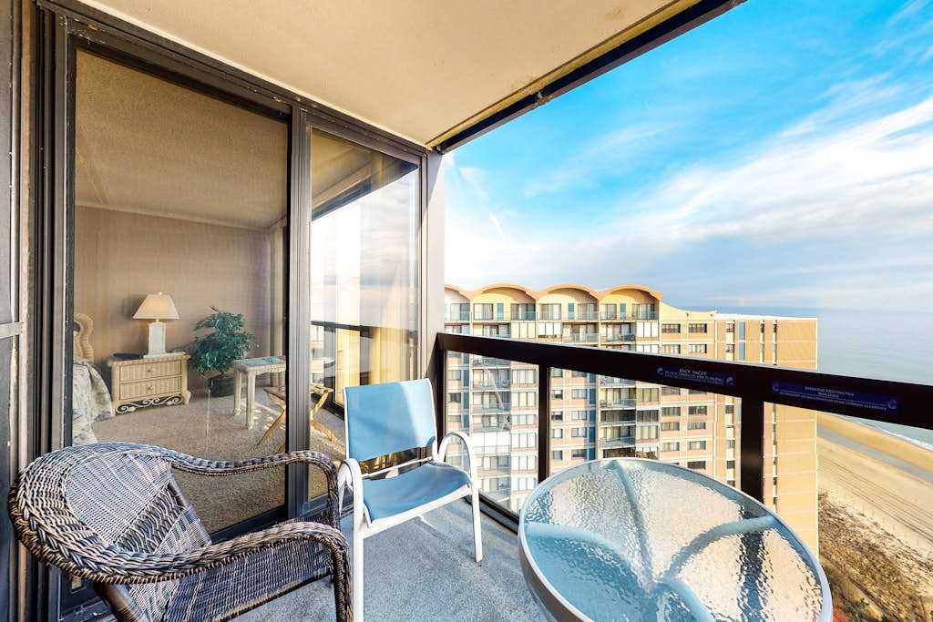 Sunny beachfront condo with balcony, central AC, pools & gym
