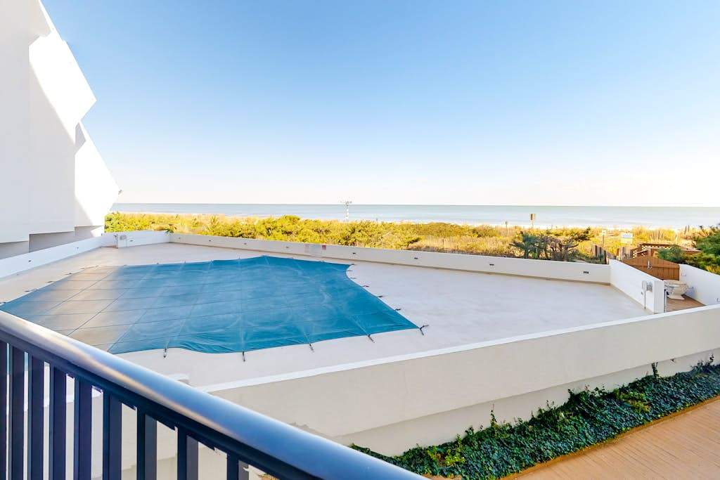 Oceanfront Condo with Covered Balcony, WiFi, AC, Laundry & Shared Pool