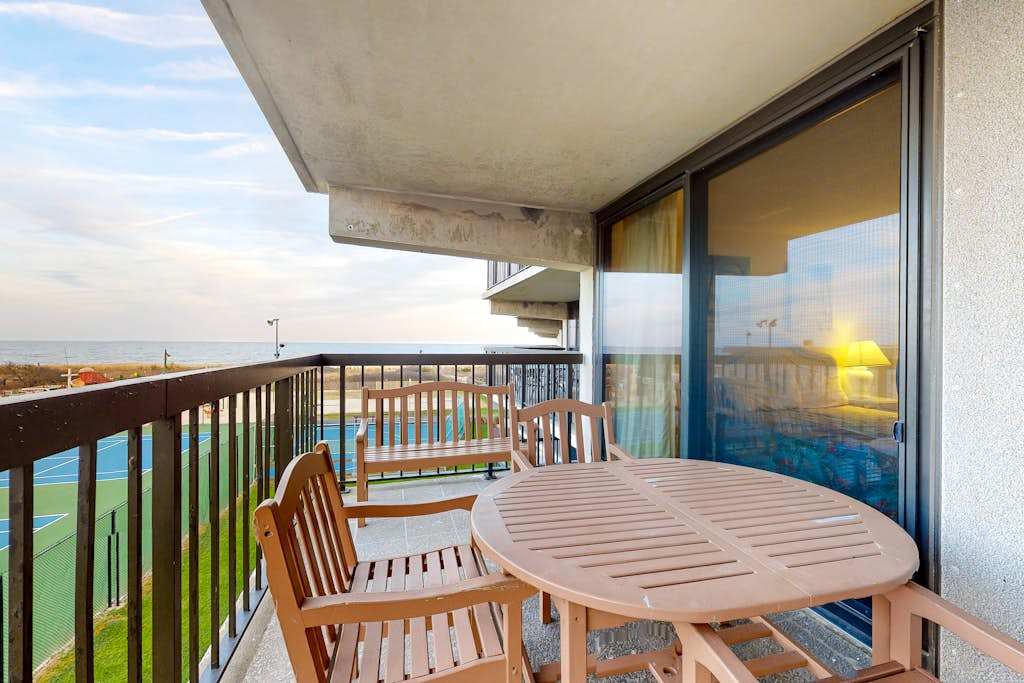 Sunny, inviting condo near the beach with balcony, pools & gym