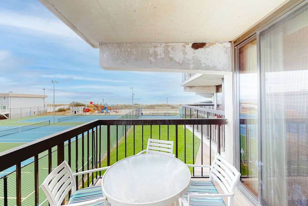 Incredible condo with tennis court views, balcony, pools, game room & gym
