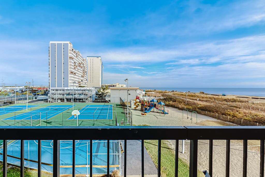 Welcoming beach retreat with tennis court views, pools, gym & sauna