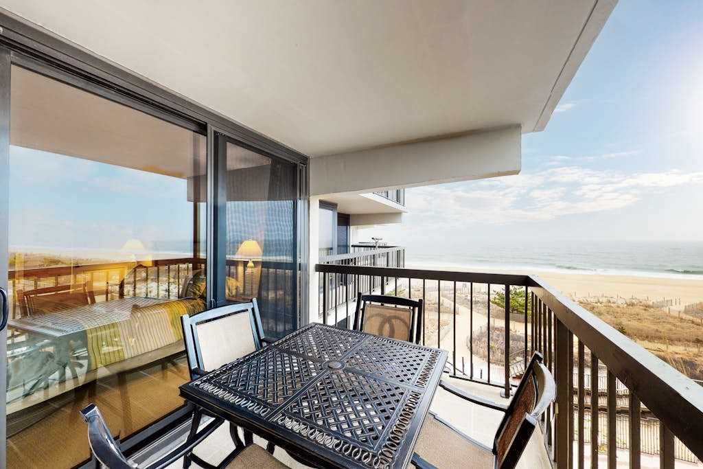 Spacious beach condo with balcony, beach views, pools, gym & AC