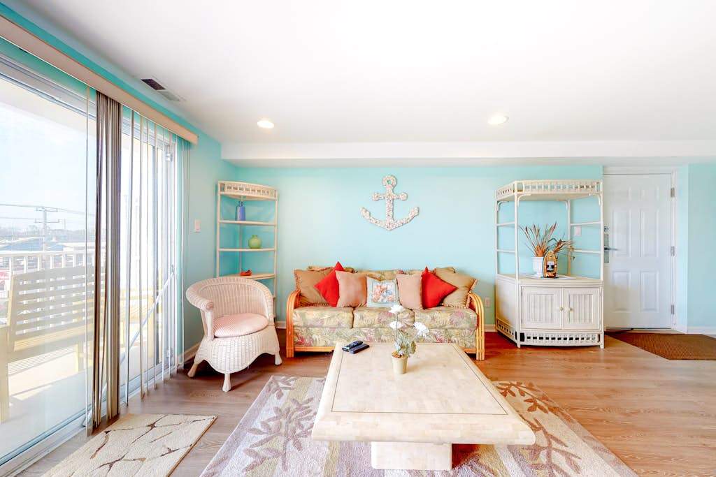 Updated, third-floor condo with balcony, washer & dryer, central AC, & WiFi - near beach