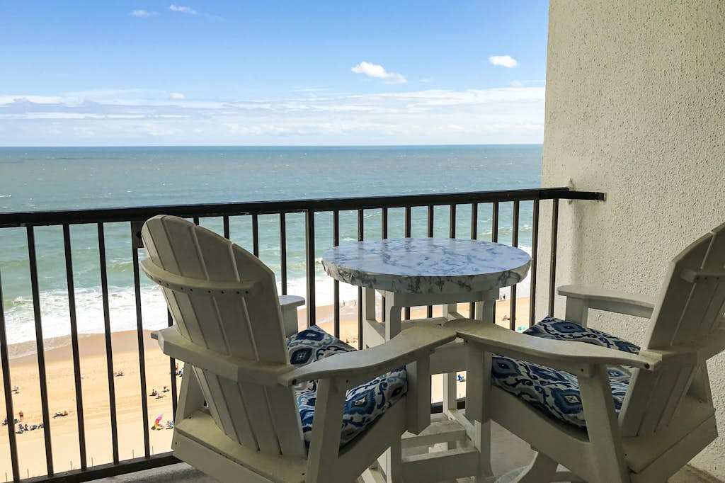 Oceanfront condo with a furnished balcony, central AC, washer & dryer, & pool