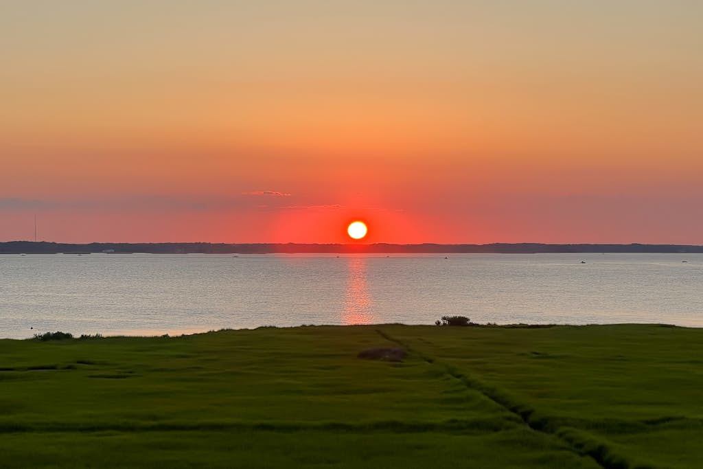 Bayfront condo with water & sunset views, balcony & pool - walk everywhere