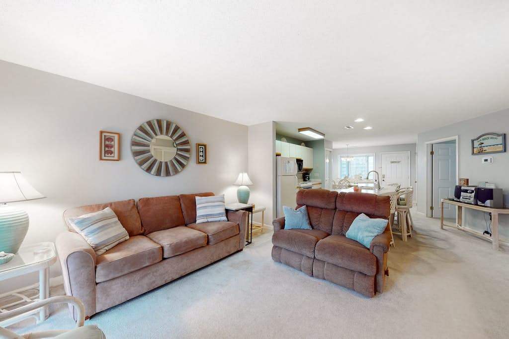 Coastal condo with a private washer & dryer, central AC, and a shared pool