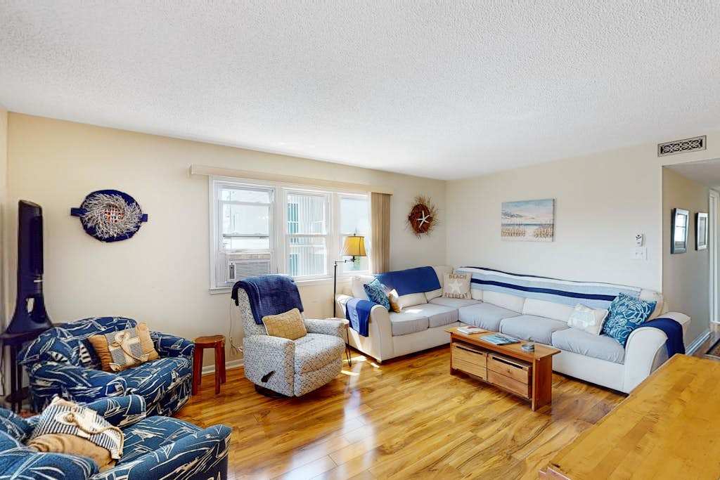 Nautical-themed condo with a balcony, open-layout, & washer & dryer - steps from the sand