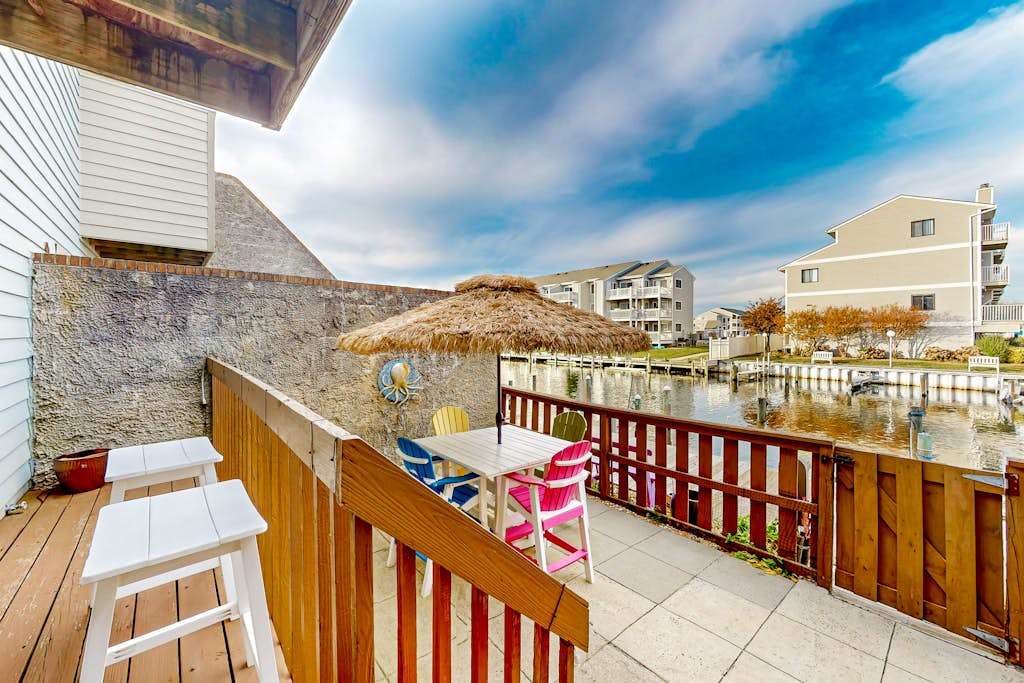 Canal-side condo near beach with water view, pool, private deck, & courtyard