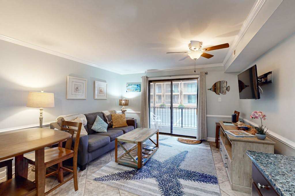 Sunny bayside condo with shared pool, balcony, full kitchen, washer & dryer, & central AC