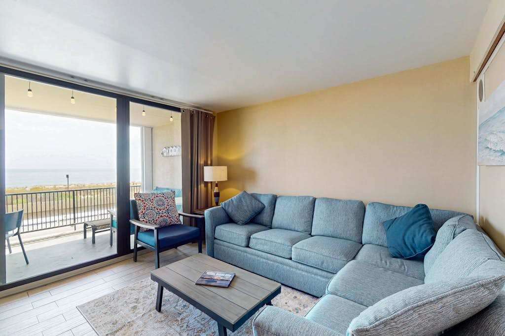 Sunny oceanfront condo with shared pool & deck, washer & dryer, & direct beach access