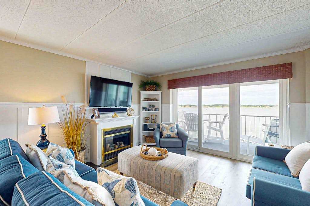 Luxury waterfront condo with water views from balcony, shared pool, AC & free WiFi