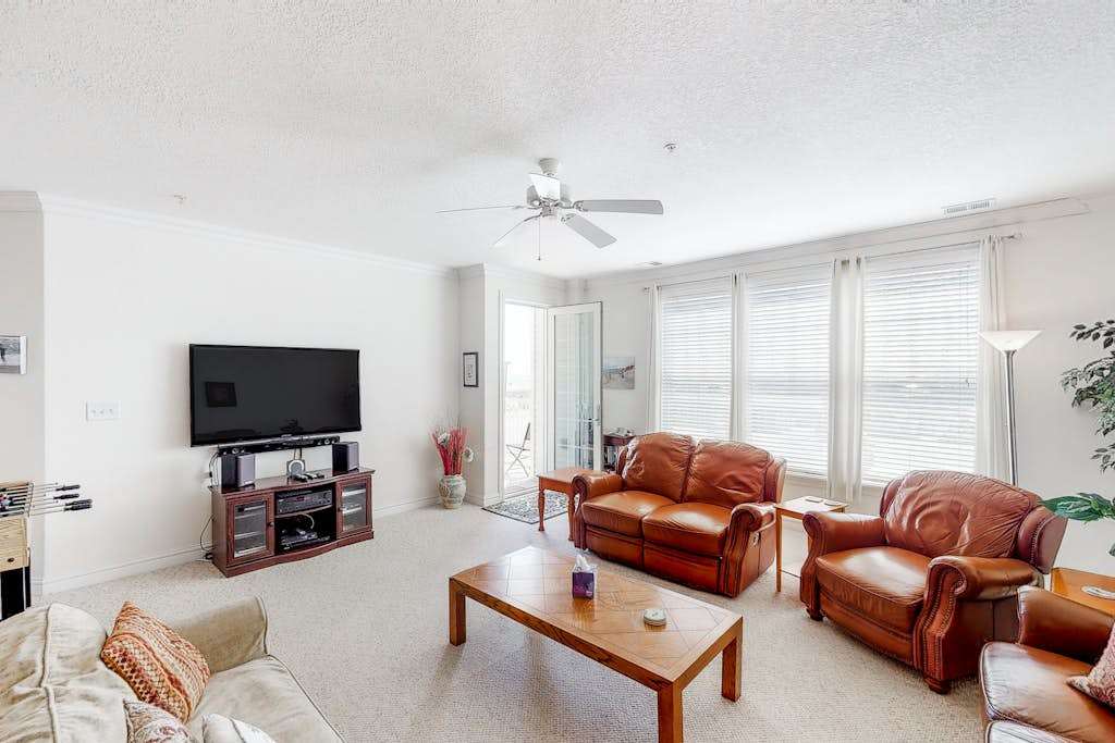 Second floor, ocean view condo with balcony, foosball, WiFi & on-site pool & gym