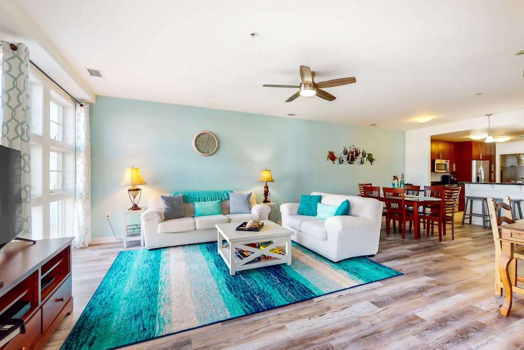 Sunlit single-level condo with pool, washer & dryer, central AC, & balcony