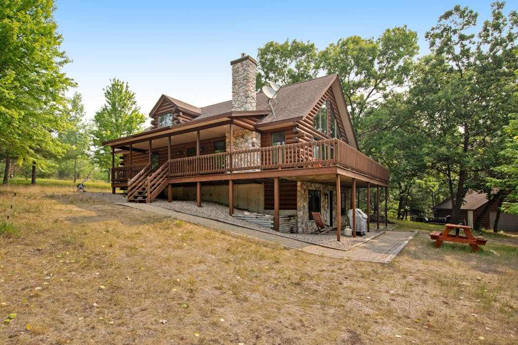 Secluded, dog-friendly home with tree-lined view, firepit, fireplace, & deck