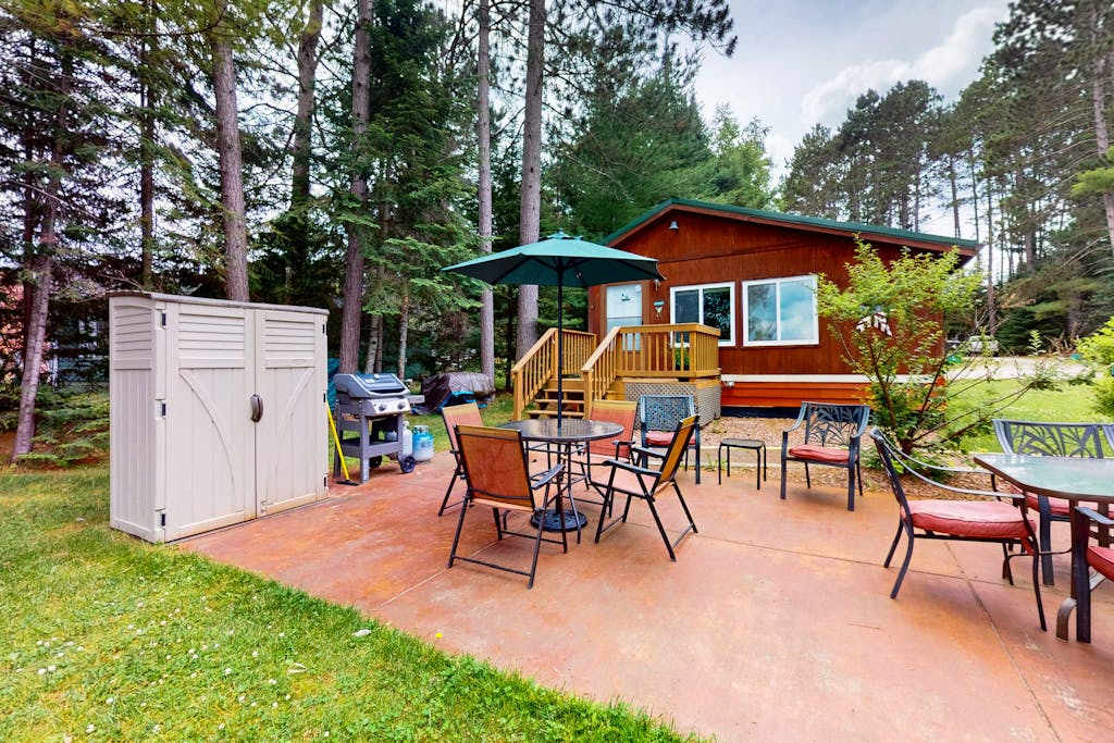Lakefront cottage with a dock, shared furnished patio, firepit, & a paddleboat