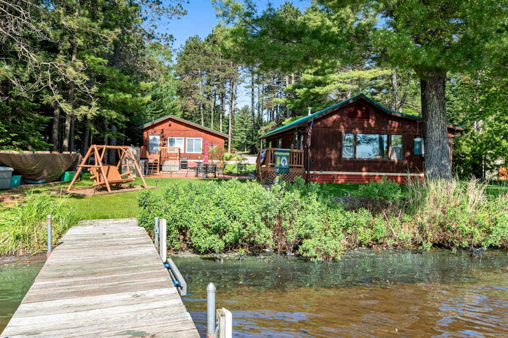 Two cozy, lakefront cottages with 2 docks, a patio, firepit, 2 gas grills, & WIFI