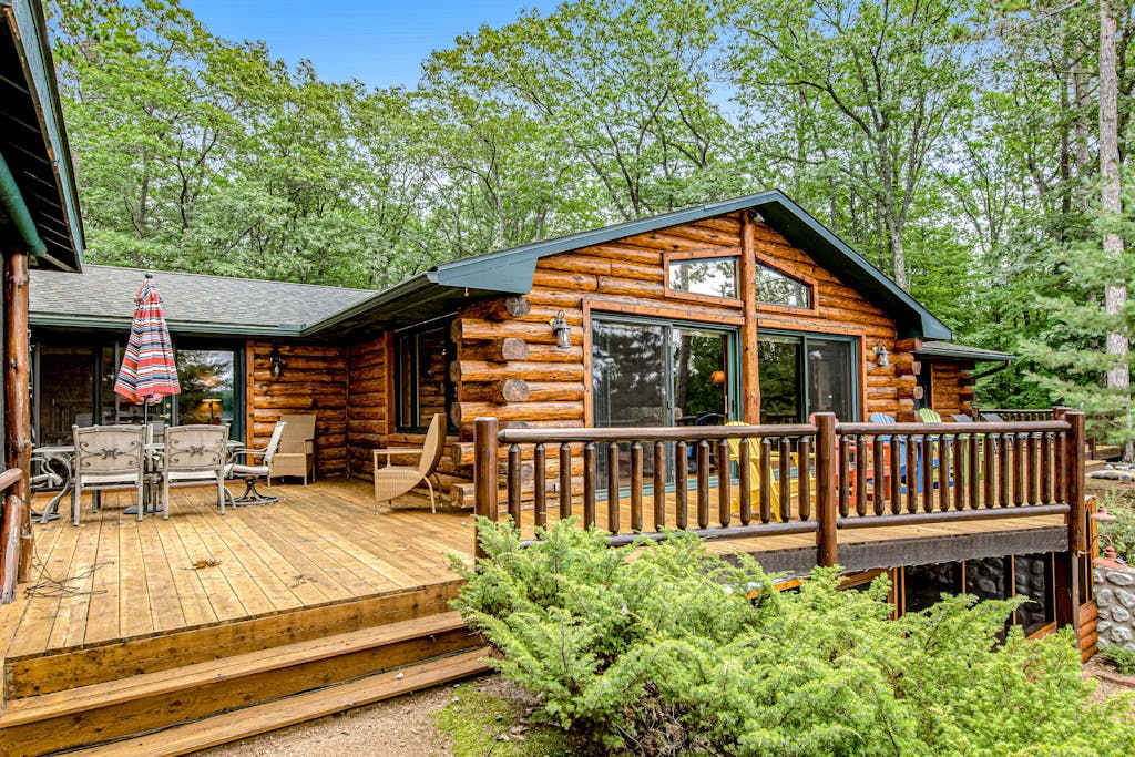 Lakefront log cabin on 3 acres with dock, gazebo & sunset views, dog friendly