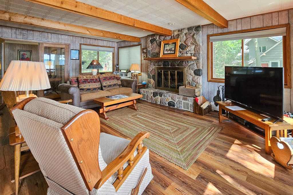 Waterfront home between 2 lakes with heated porch, dock & kayaks