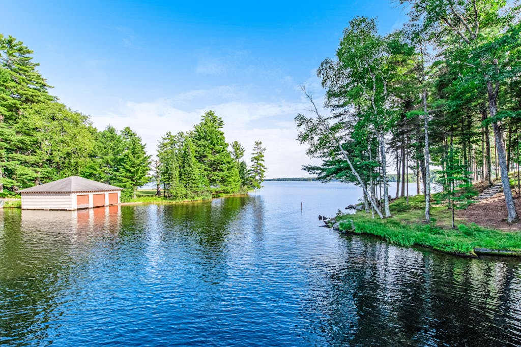 Dog-friendly, lakefront getaway with a wraparound balcony, beach, & boat access