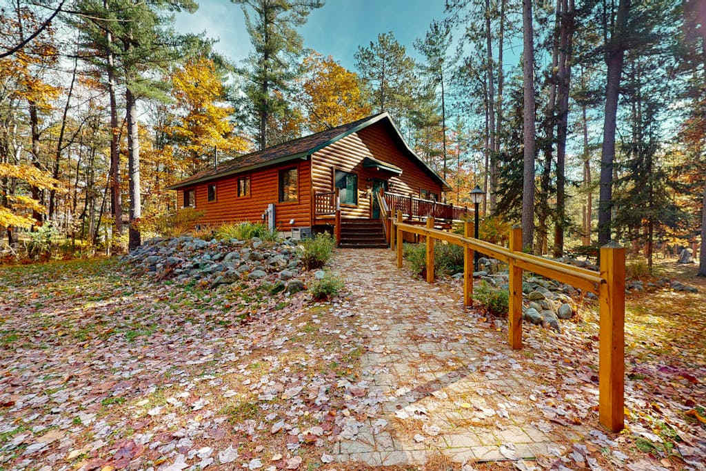 Riverfront home on the Manitowish Riverway with fire pit, kayaks & boat house