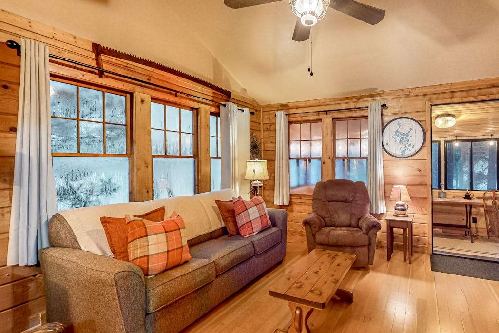 Lakeside cabin with a firepit, sunroom, & seasonal dock