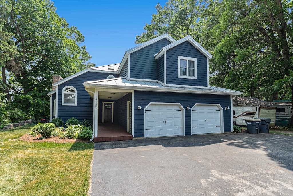 Serene lakefront retreat with an expansive deck, dock access, game room, & AC