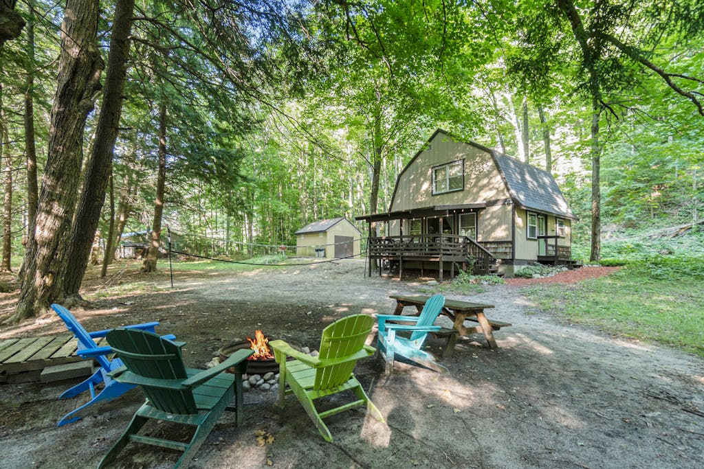 Riverfront cabin on the Betsie with private dock, kayaks & bikes - 2 dogs OK