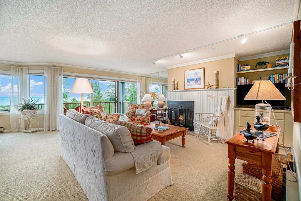 Lake-view condo with private beach, fireplace, deck, washer & dryer, streaming
