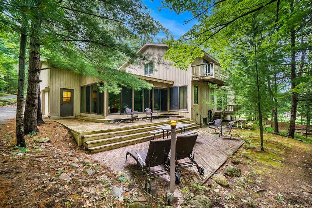 Two-story home with a patio, sunroom, balcony, & washer & dryer access