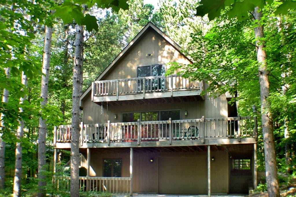 Stunning two-story home in the trees with a firepit, furnished deck, & balcony