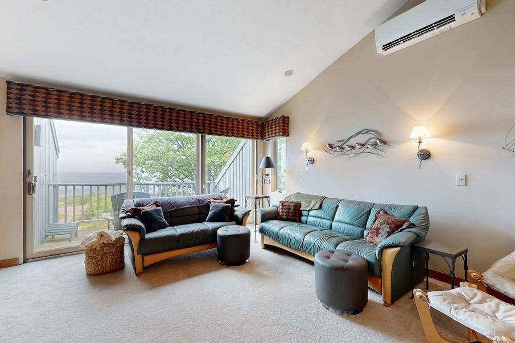 Lakefront condo with deck, gorgeous view, fireplace, & washer & dryer