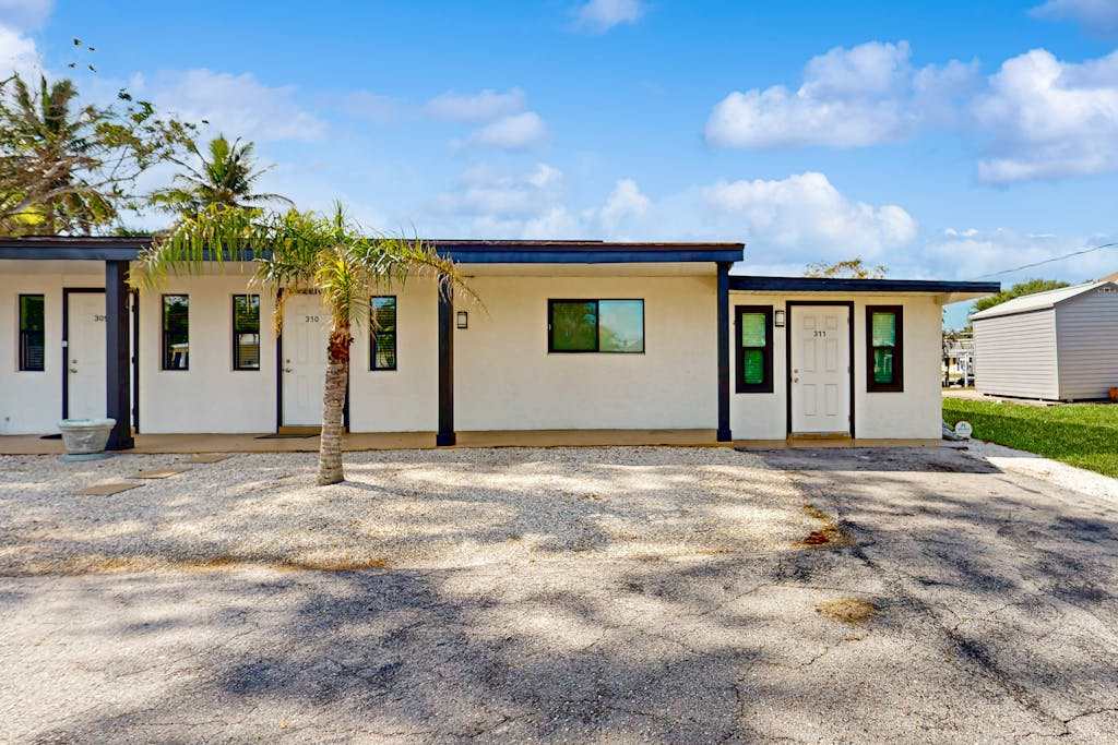 Canal front apartment with waterfront views private patio & yard
