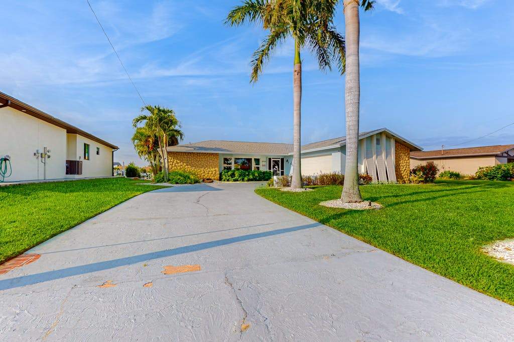 Dog friendly tropical home on the canal with screened patio with pool & private dock