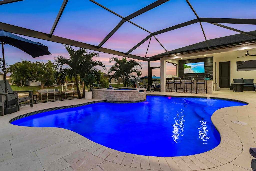 Luxury canal front home with heated pool pool spa grill fireplace washer & dryer & AC