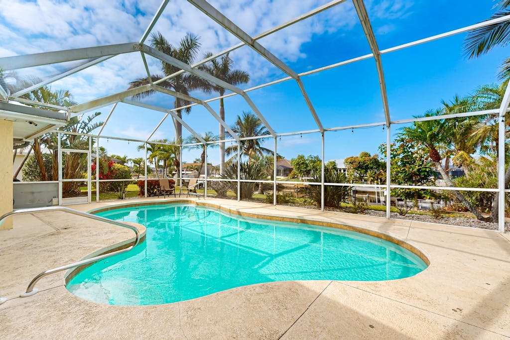 Waterfront home with private pool lanai dock & tiki hut