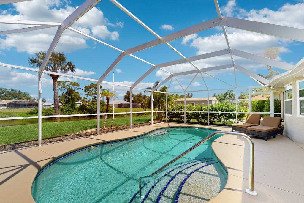 Snowbird friendly home with private pool water views patio & sunroom